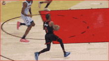 a basketball player with the number 8 on his back is dribbling the ball