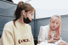 a woman wearing a yellow sweatshirt that says cancel on it