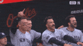 a group of baseball players wearing new york jerseys are sitting in a dugout