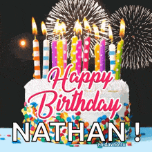 a birthday cake with candles and fireworks and the name nathan on it