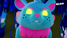 a blue and pink stuffed animal with glowing eyes and the word ok on the bottom right