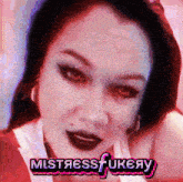 a close up of a woman 's face with the words mistressfukeay in pink