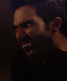 a close up of a man 's face with red eyes and the words " breakmyheartfuck tumblr " in the corner