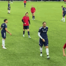 a group of soccer players on a field one of whom is wearing a jersey that says xbox