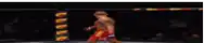 a man in a boxing ring with his arms in the air .