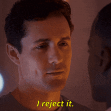 a man says i reject it next to another man 's face