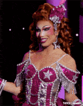 a woman in a pink and silver dress with a star on the front