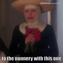 a nun is holding a bouquet of flowers and says to the nunnery with this one