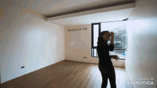 a woman is standing in a room with the words bedroom # 3 written on the wall