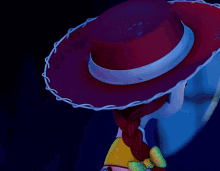 a close up of a toy story character wearing a red cowboy hat