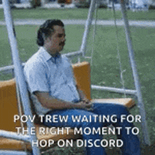 a man is sitting on a swing in a park and waiting for the right moment to hop on discord .