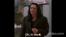 a man in a black suit says " oh hi marx "