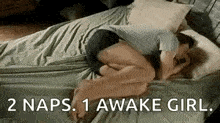 a man is sleeping on a bed with a woman and the words `` 2 naps . 1 awake girl . ''