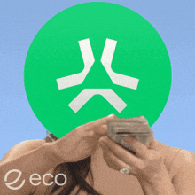 a woman is holding a stack of money in front of a green circle with the word eco on it
