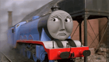 a blue and red train with a face that says i on it