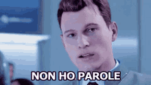 a man in a suit and tie is making a funny face and says non ho parole .