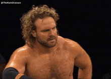 a shirtless wrestler with the hashtag thekamdreesen on the bottom