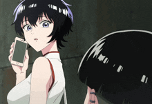 a girl with short black hair is holding a cell phone in her right hand