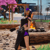 a woman in a black and purple outfit is standing in front of a fire
