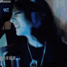 a woman is singing into a microphone with the date 09/9000 on the bottom