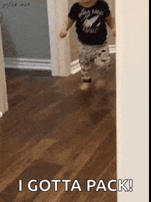 a baby is running down a hallway with the words `` i gotta pack '' behind him .