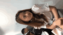 a woman wearing a white shirt with the letter n on the front
