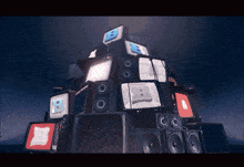 a stack of televisions and speakers with the letter b on the top