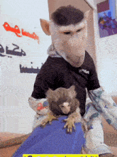 a man dressed as a monkey is holding a small monkey on his lap