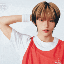 a young man wearing a red shirt that says boys in planet
