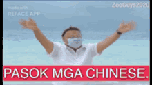 a man wearing a face mask is standing in front of the ocean