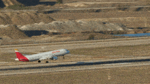 a iberia airplane is taking off from an airport runway