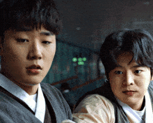 two young men are standing next to each other and one has a bandage on his arm