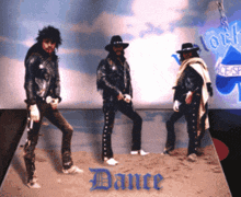 three men are dancing in front of a sign that says " dance " on it