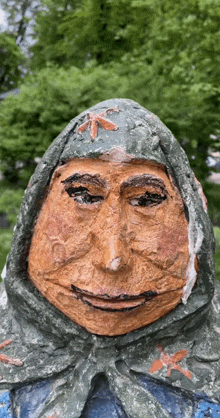 a statue of a woman with a scarf around her head is smiling