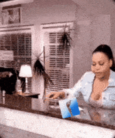 a woman is standing at a counter with a picture of a woman on it and a sign above her that says blessed