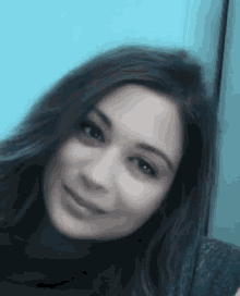 a close up of a woman 's face with her eyes closed