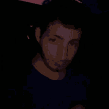 a man with a beard wears a blue shirt