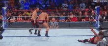 two men are wrestling in a ring and one has the number 10 on his shorts .