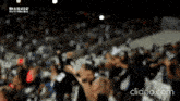 a blurry picture of a crowd of people with the words marado written in the upper left corner