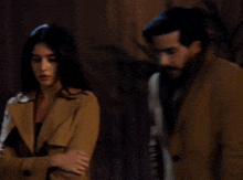a man and woman are standing next to each other