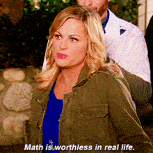 a woman in a green jacket with the words math is worthless in real life