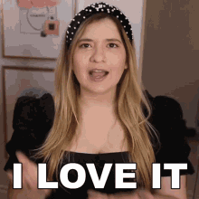 a woman wearing a headband with pearls says i love it