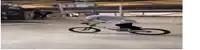 a man is riding a bicycle on a concrete surface .