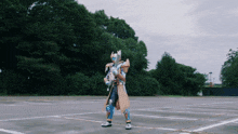 a person in a costume is standing in a parking lot with trees in the background