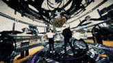 a group of people are dancing in a room with a disco ball hanging from the ceiling