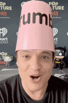 a man is wearing a pink hat that says trump