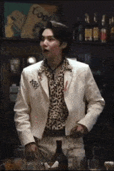 a man in a leopard print shirt and a white jacket
