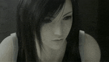 a close up of a woman 's face with black hair