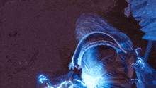 a person is holding a lightning bolt in their hand while standing in a dark room .