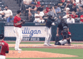 a baseball game is being played in front of a sign that says indy indians